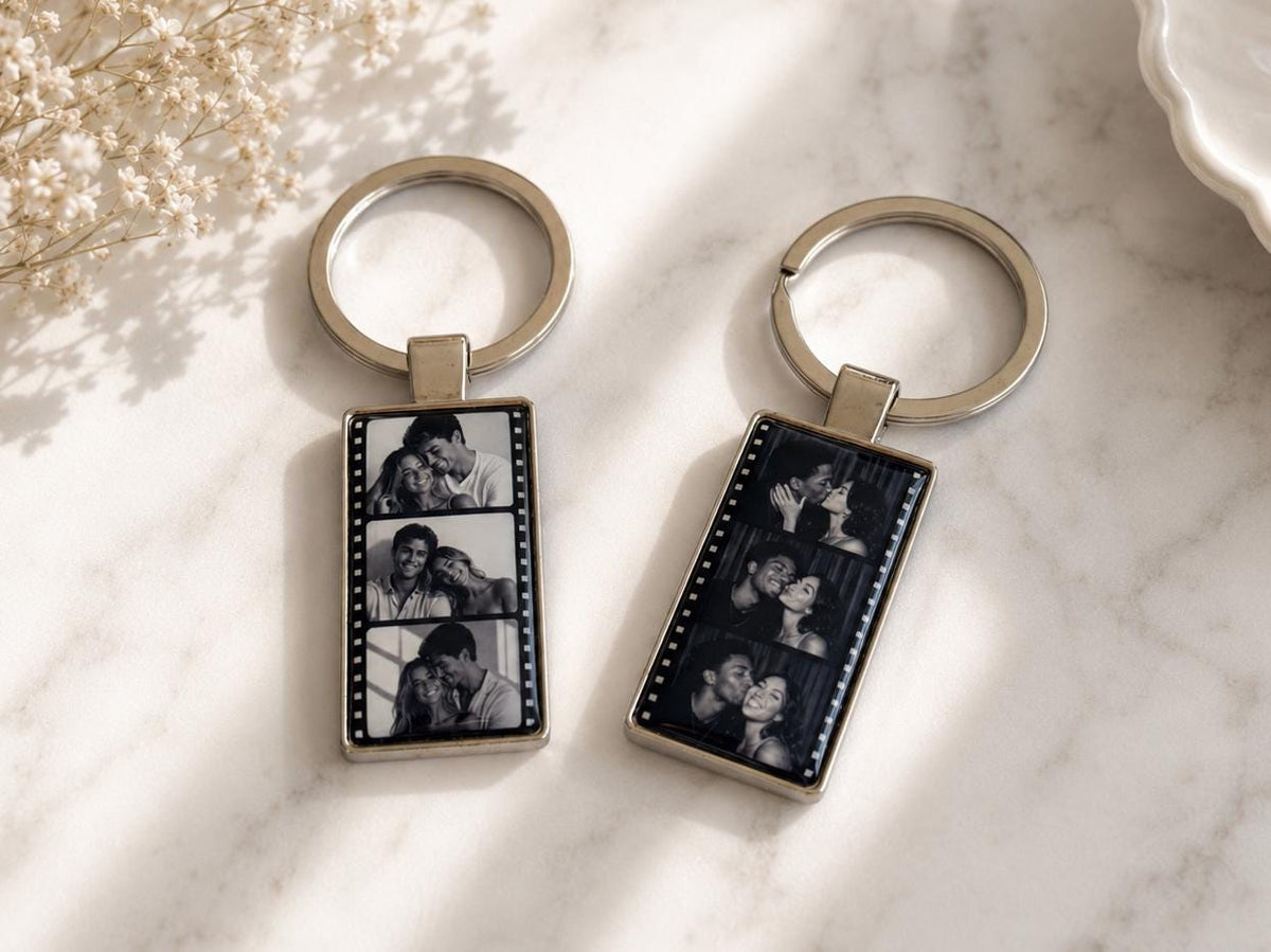 Personalized film strip photo keychain attached to car keys showing three couple photos in black and white