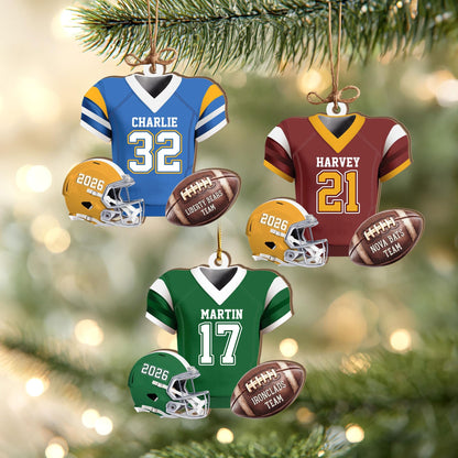 May include: Three sets of football-themed Christmas ornaments, each featuring a jersey with a name and number, a helmet labeled 2026, and a football inscribed with a team name. The jerseys are blue, maroon, and green with matching helmets.