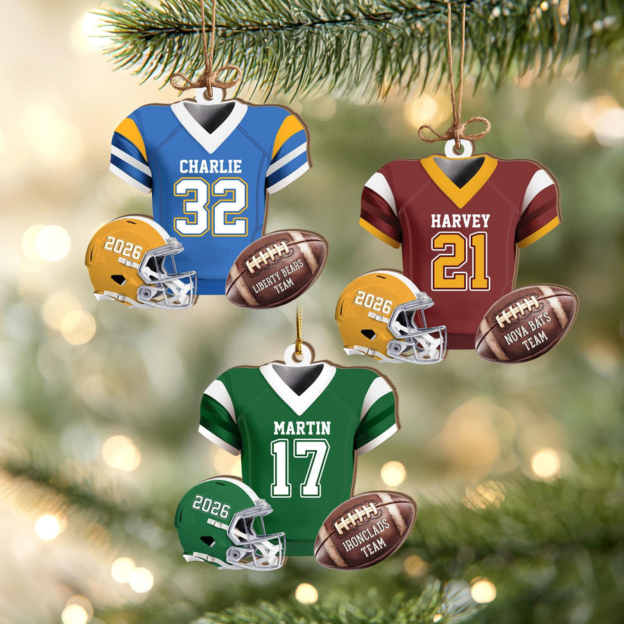 May include: Three sets of football-themed Christmas ornaments, each featuring a jersey with a name and number, a helmet labeled 2026, and a football inscribed with a team name. The jerseys are blue, maroon, and green with matching helmets.