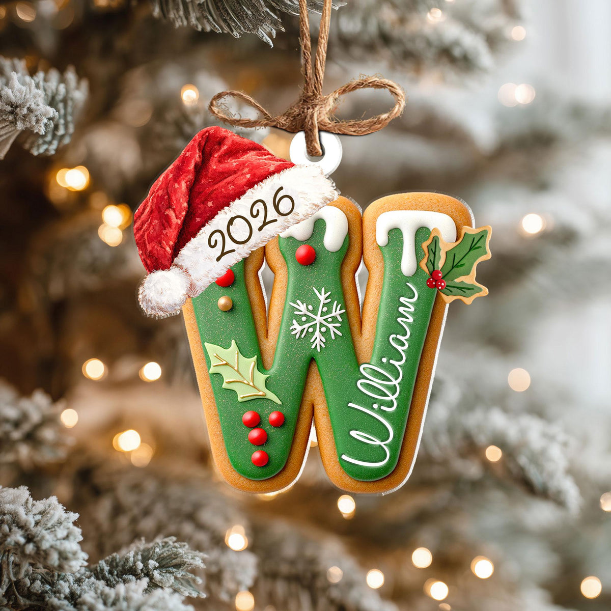 May include: A gingerbread-style letter W Christmas ornament featuring a red Santa hat with the year 2026 printed on the brim. The letter is decorated with green icing, white snowflake details, red holly berries, green leaves, and the name William.