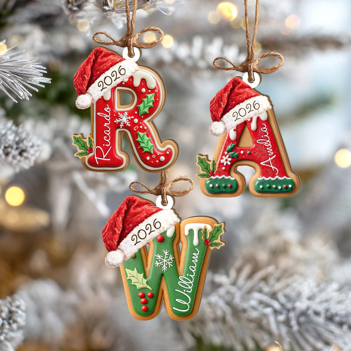 May include: Three hanging Christmas ornaments shaped like the letters R, A, and W. Each letter features a red or green gingerbread-style finish, a white Santa hat with the year 2026, and a name: Ricardo, Amelia, or William, tied with twine.
