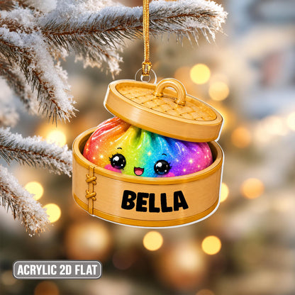 A 2D flat acrylic hanging ornament shaped like a bamboo steamer basket containing a rainbow-colored dumpling with a smiling face and large eyes. The side of the steamer is printed with the name BELLA in bold black capital letters.