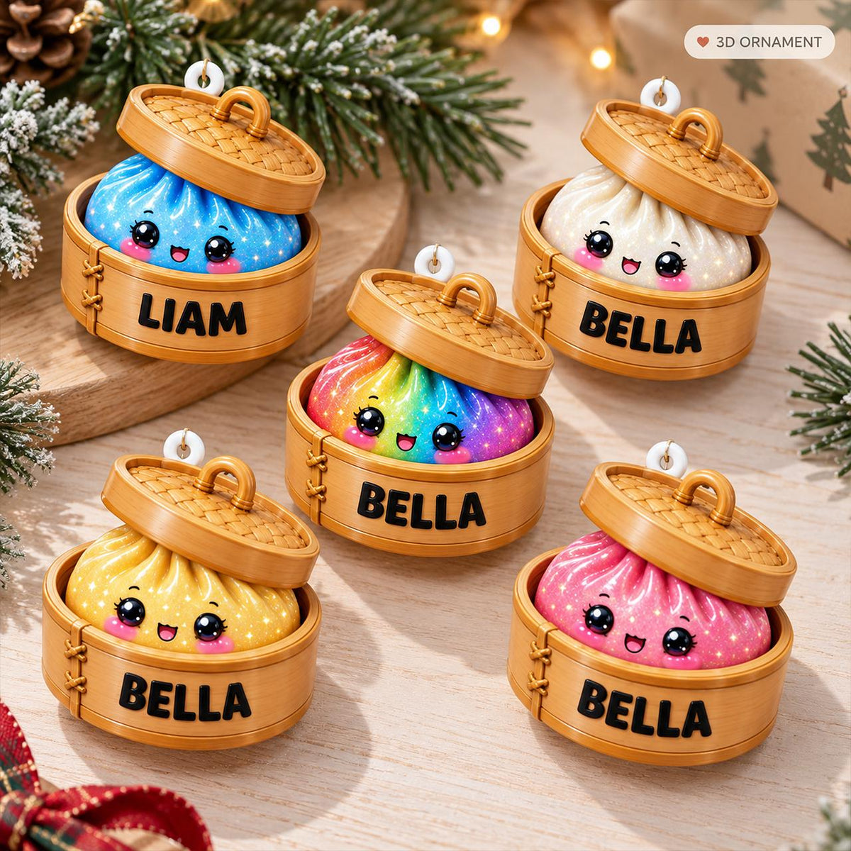 Five round ornaments shaped like dumplings in bamboo steamers. Each features a smiling face with large eyes and a lid. The dumplings are blue, white, rainbow, yellow, and pink. The steamers are labelled with the names LIAM or BELLA.