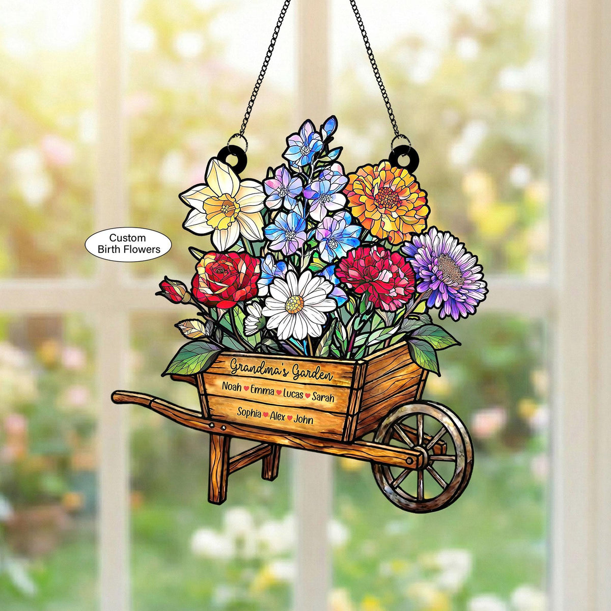 May include: A hanging wooden wheelbarrow filled with colorful flowers, including red roses, white daisies, and yellow daffodils. The wheelbarrow has the text "Grandma's Garden" and names. The text "Custom Birth Flowers" is also present.