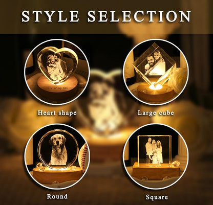 A collection of four illuminated crystal displays labeled STYLE SELECTION. The shapes include a heart, a large cube, a round disc, and a square block, each featuring an engraved photograph and resting on a circular wooden base.