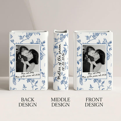 Three white ceramic vases featuring a blue floral pattern. The front and back designs display a black and white photograph of a person holding a child, with the text "Mom est. 1996" and "Mom of the groom est. 2026". The middle vase reads "Mother of the groom 08.25.2026".