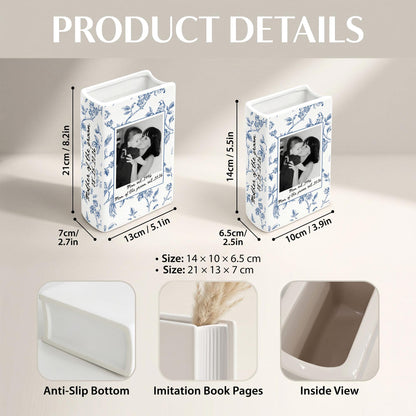Two white ceramic book-shaped vases with blue floral patterns and a black and white photo print. The larger vase measures 8.2 inches by 5.1 inches by 2.7 inches, and the smaller vase measures 5.5 inches by 3.9 inches by 2.5 inches.