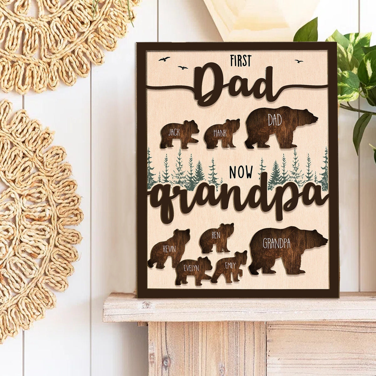 May include: A wooden sign with a brown frame and a woodgrain background. The sign features a silhouette of a bear family with the text "First Dad Now Grandpa". The bear silhouettes are labeled with names, including "Jack", "Hank", "Dad", "Kevin", "Ben", "Grandpa", "Evelyn", and "Emily".