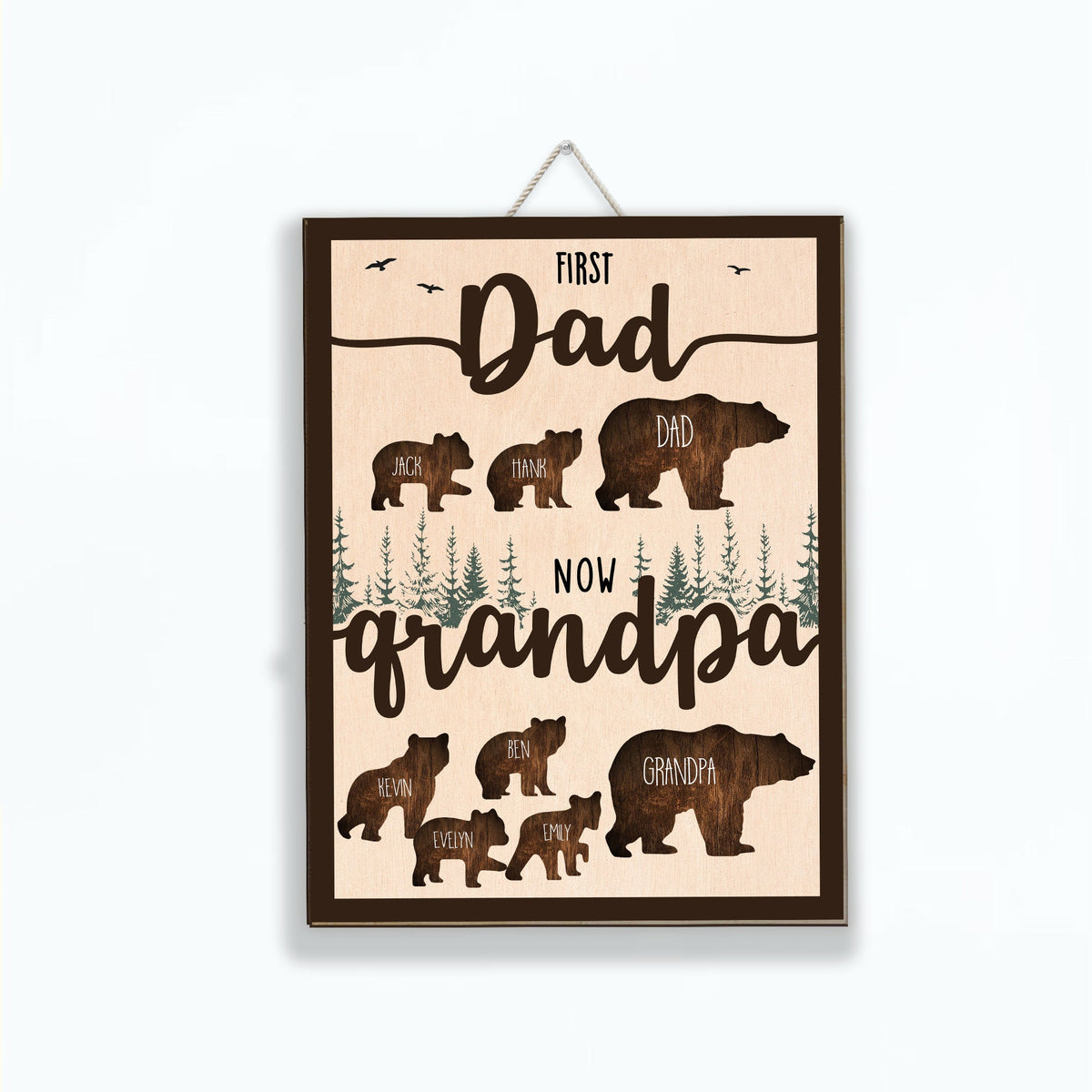 May include: A wooden sign with a brown background and a light brown wood grain texture. The sign features a silhouette of a bear family with the text "First Dad Now Grandpa" and the names of the family members.
