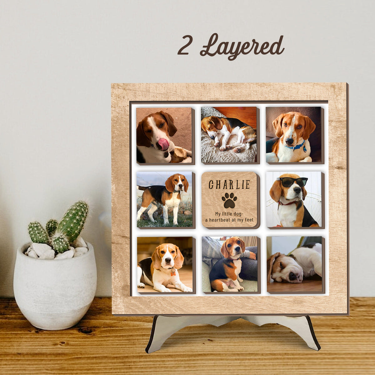 May include: A 2-layered wooden photo display with nine square images of a beagle dog. The display has a brown wooden frame and a stand. The text "CHARLIE" and "My little dog - a heartbeat at my feet" is engraved on one of the images.