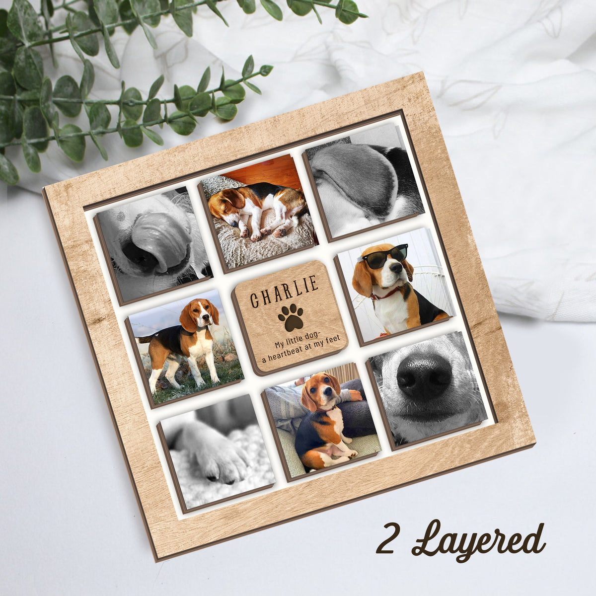 May include: A wooden photo frame with a light brown wood finish. The frame holds nine square photos of a beagle dog. The frame has a small plaque with the text "CHARLIE My little dog - a heartbeat at my feet".
