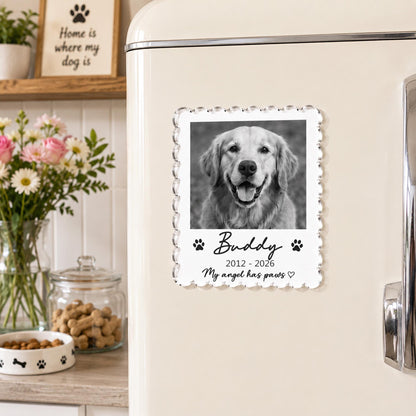 May include: A rectangular acrylic magnet with scalloped edges featuring a black and white photograph of a dog. The text reads Buddy, 2012-2026, and My angel has paws, accompanied by two small black paw print icons and a heart symbol.
