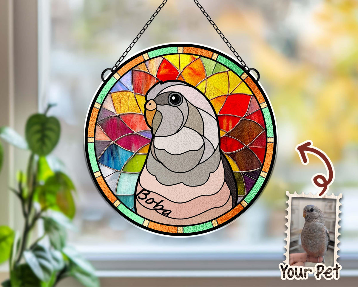 May include: A stained glass window hanging with a colorful design of a parrot with the name "Boz" written on it. The window is surrounded by a metal frame. A smaller image of a parrot is in the bottom right corner with the text "Your Pet".