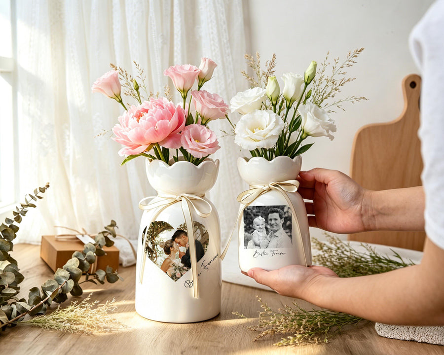 Two white ceramic vases with scalloped rims, each tied with a thin beige ribbon. The larger vase features a heart-shaped photo of a couple, while the smaller vase displays a rectangular photo of a family with the text "Bestie Forever."