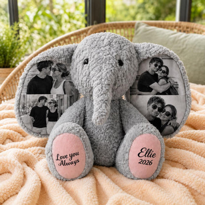 A gray plush elephant toy with large ears featuring printed black and white photographs of couples. The elephant has pink foot pads with the text Love you Always on the left foot and the name Ellie and the year 2026 on the right foot.