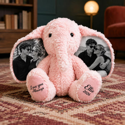 A pink plush elephant toy with large ears featuring black and white printed photographs of a couple. The left foot pad is embroidered with the text Love you Always, and the right foot pad features the text Ellie 2026 in black script.