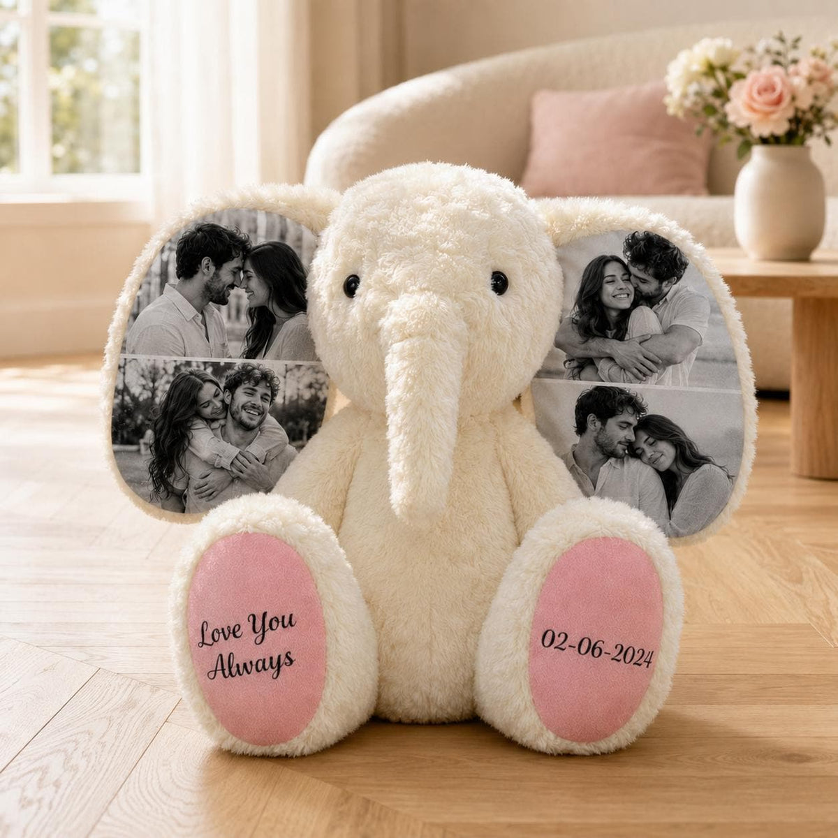 A cream-colored plush elephant toy featuring black and white photo prints on its large ears. The left foot pad is printed with the text Love You Always, and the right foot pad displays the date 02-06-2024 in a dark script font.