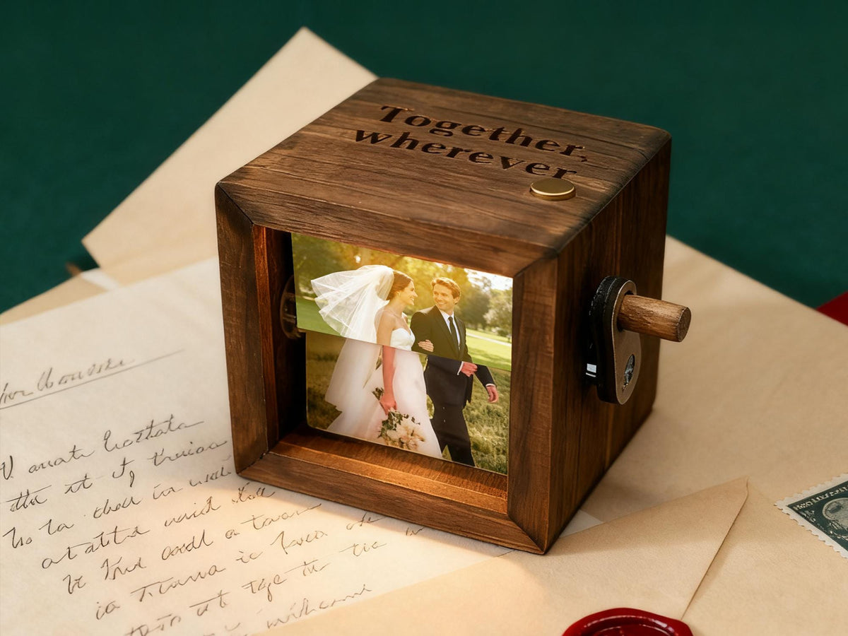 A wooden photo cube with a picture of a wedding couple visible through a window. The cube has the words "Together, wherever" engraved on top. A small wooden handle and a metal lock are on the side.