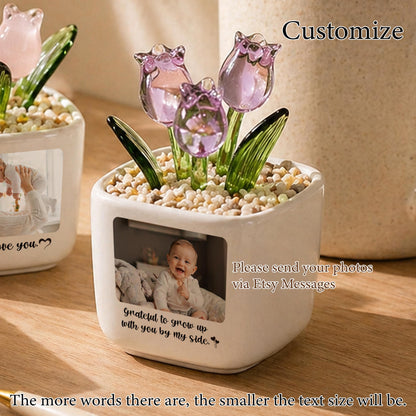 A white ceramic pot with a photo of a baby, glass tulips, and small stones. The text on the pot reads "Grateful to grow up with you by my side." and "Please send your photos via Etsy Messages."