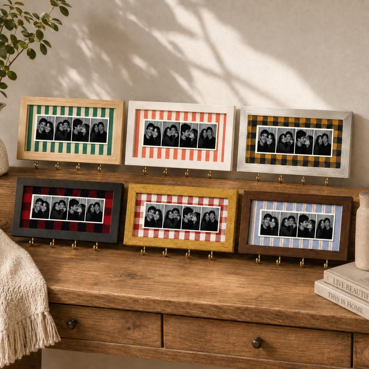 Six rectangular wall-mounted photo frames with hooks, each featuring a unique fabric backing pattern including green stripes, red stripes, yellow plaid, black plaid, yellow gingham, and blue stripes, displaying black and white photo strips.