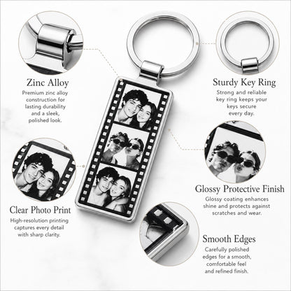 A rectangular metal keychain featuring a film strip design with three black and white portrait photos of a couple. The keychain includes a sturdy silver-toned ring and has a glossy protective finish with smooth, polished edges.