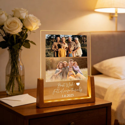 A lighted photo display with two family photos. The display has a wooden base and a clear acrylic front. The text "Best Wish! Full of love for the family 1.6.2025" is illuminated on the front.