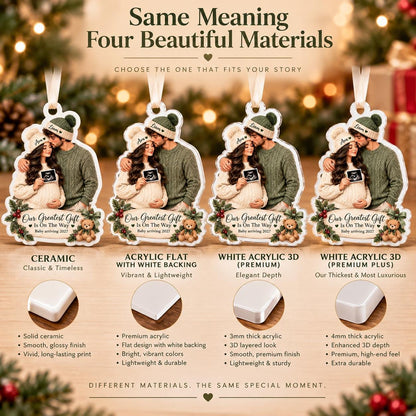 May include: Four hanging ornaments featuring a couple with a sonogram image, the text 'Our Greatest Gift Is On The Way' and 'baby arriving 2027'. The image displays four material options: ceramic, flat acrylic with white backing, and two 3D white acrylic versions.