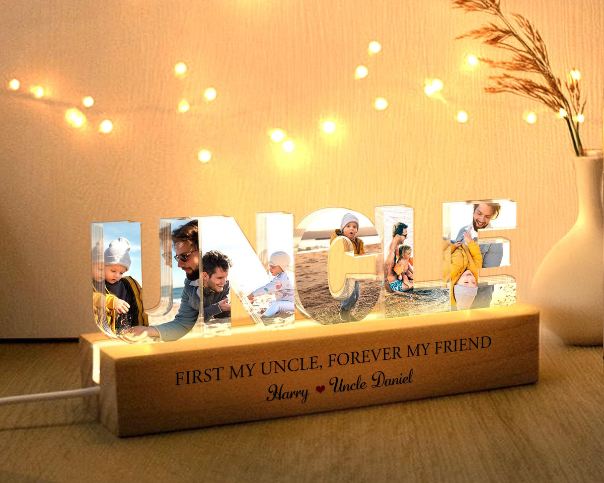May include: A lighted wooden sign with the word "UNCLE" spelled out in clear acrylic letters. Each letter has a photo of a different person inside. The base of the sign has the text "First my uncle, forever my friend" and "Harry Uncle Daniel".
