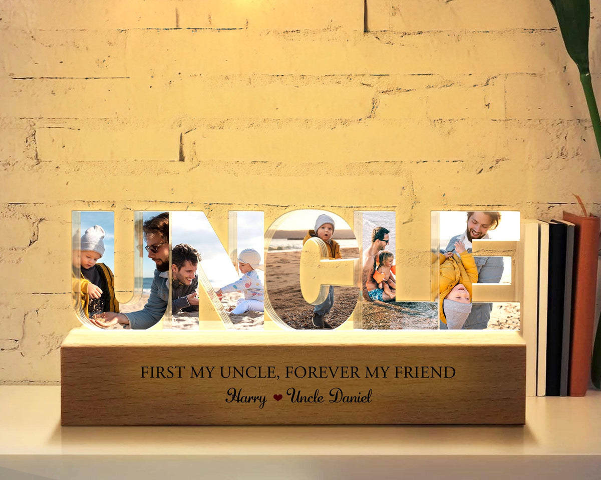 May include: A wooden light-up sign with the word "UNCLE" spelled out in large letters. Each letter has a photo of a different person inside. The sign has a wooden base with the text "First my uncle, forever my friend. Harry Uncle Daniel".