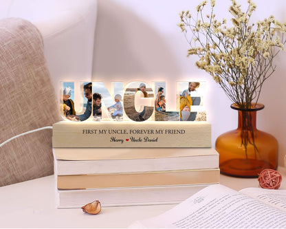 May include: A wooden light-up sign with the word "UNCLE" spelled out in large letters. Each letter has a photo of a person inside. The sign has a wooden base with the text "First my uncle, forever my friend" and the names "Harry" and "Uncle Daniel".