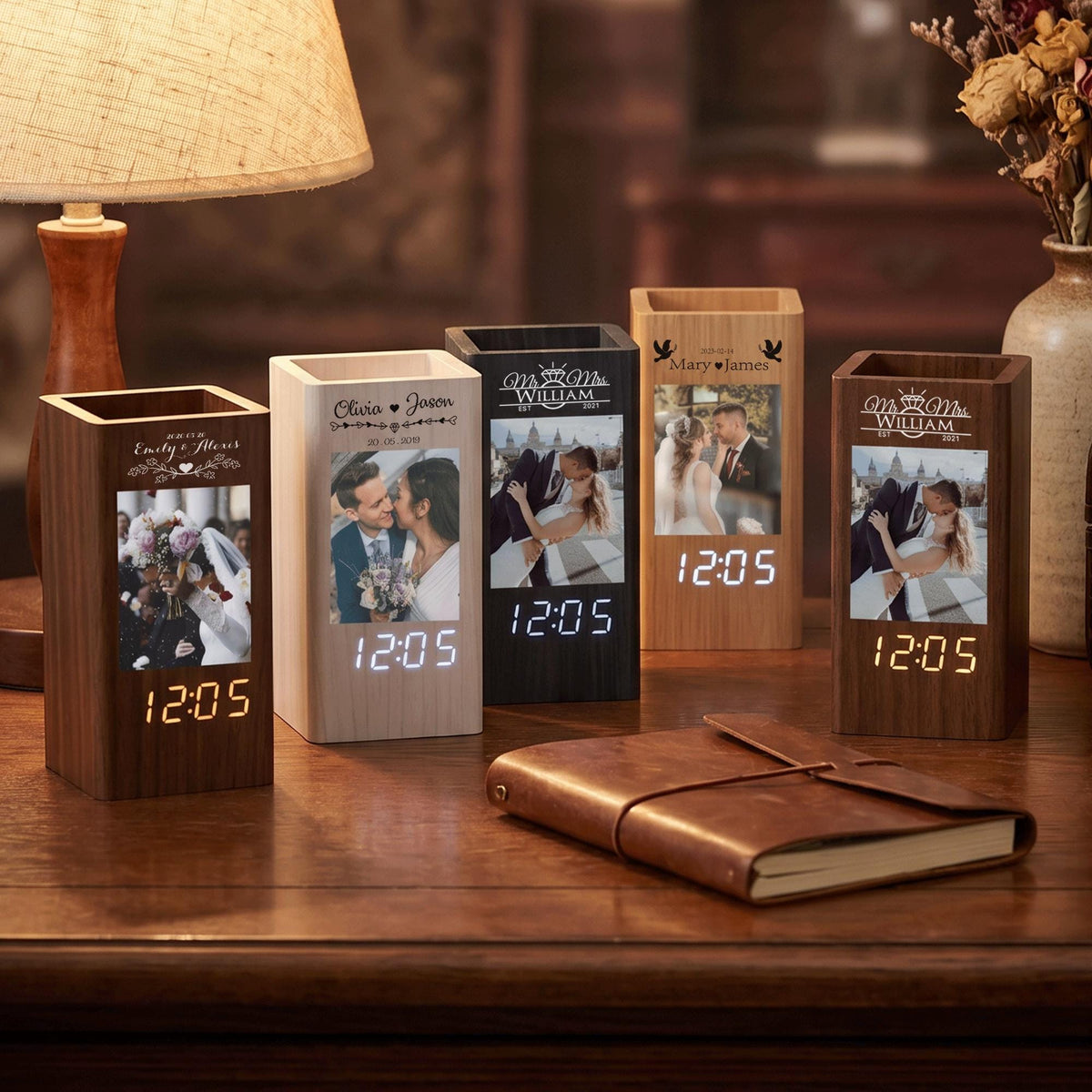 Five rectangular wooden desk organizers with integrated digital clocks. Each unit features a vertical photo display, personalized engraved names, and a glowing digital time display showing 12:05 in white or orange light.