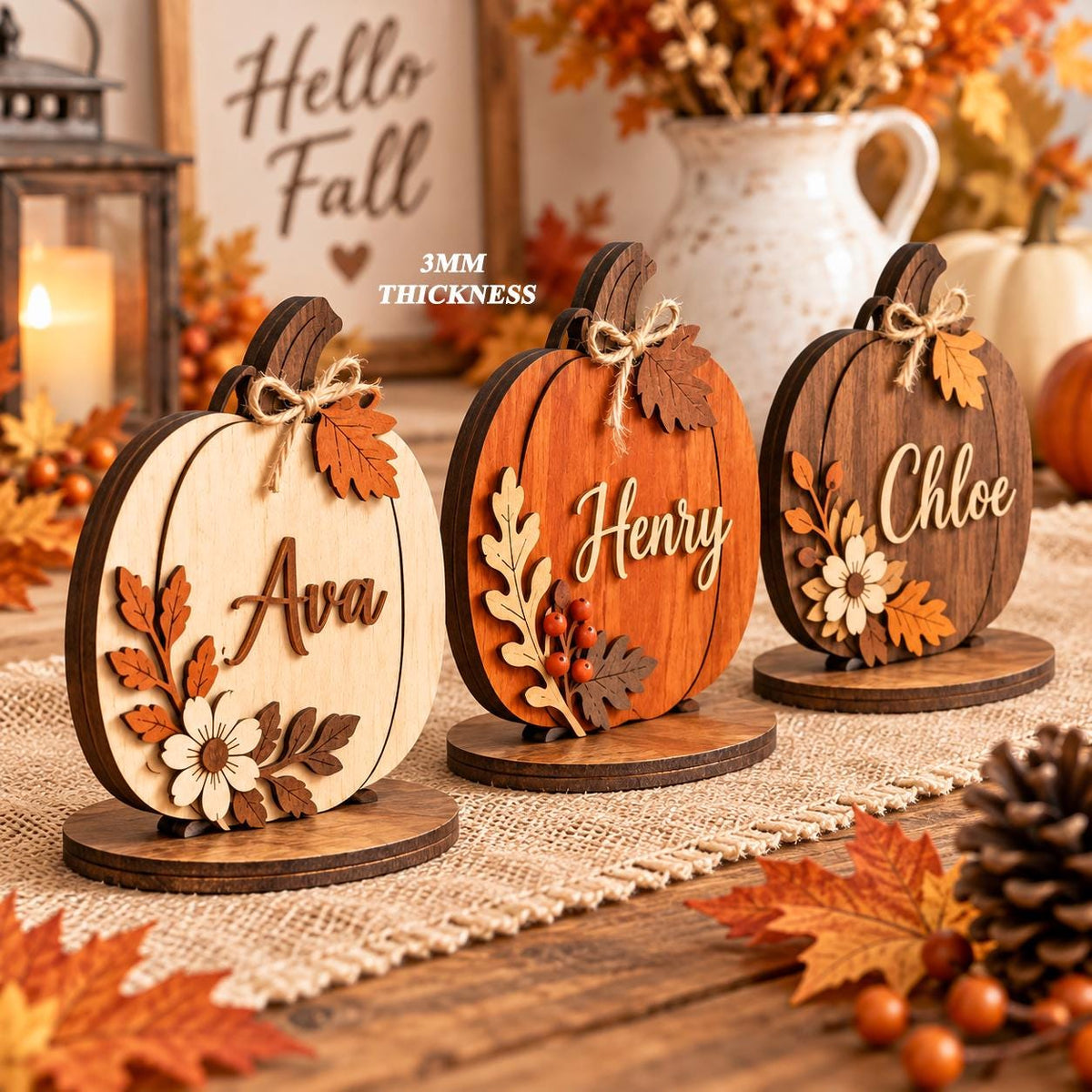 May include: Three wooden pumpkin decorations with 3mm thickness, each featuring a unique name: Ava, Henry, and Chloe. The pumpkins are adorned with layered wooden leaves, flowers, and twine bows, standing on circular wooden bases.
