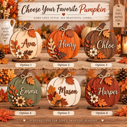 May include: Six wooden pumpkin decorations on circular bases, each featuring a unique color, a name in script, and autumn-themed embellishments like leaves, berries, and twine bows. The sign above reads: Choose Your Favorite Pumpkin.
