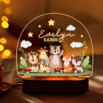 May include: A wooden night light with a clear acrylic dome featuring a whimsical woodland scene with a lion, giraffe, bear, fox, and deer. The dome also includes the name "Evelyn" and the date "5.4.2023".