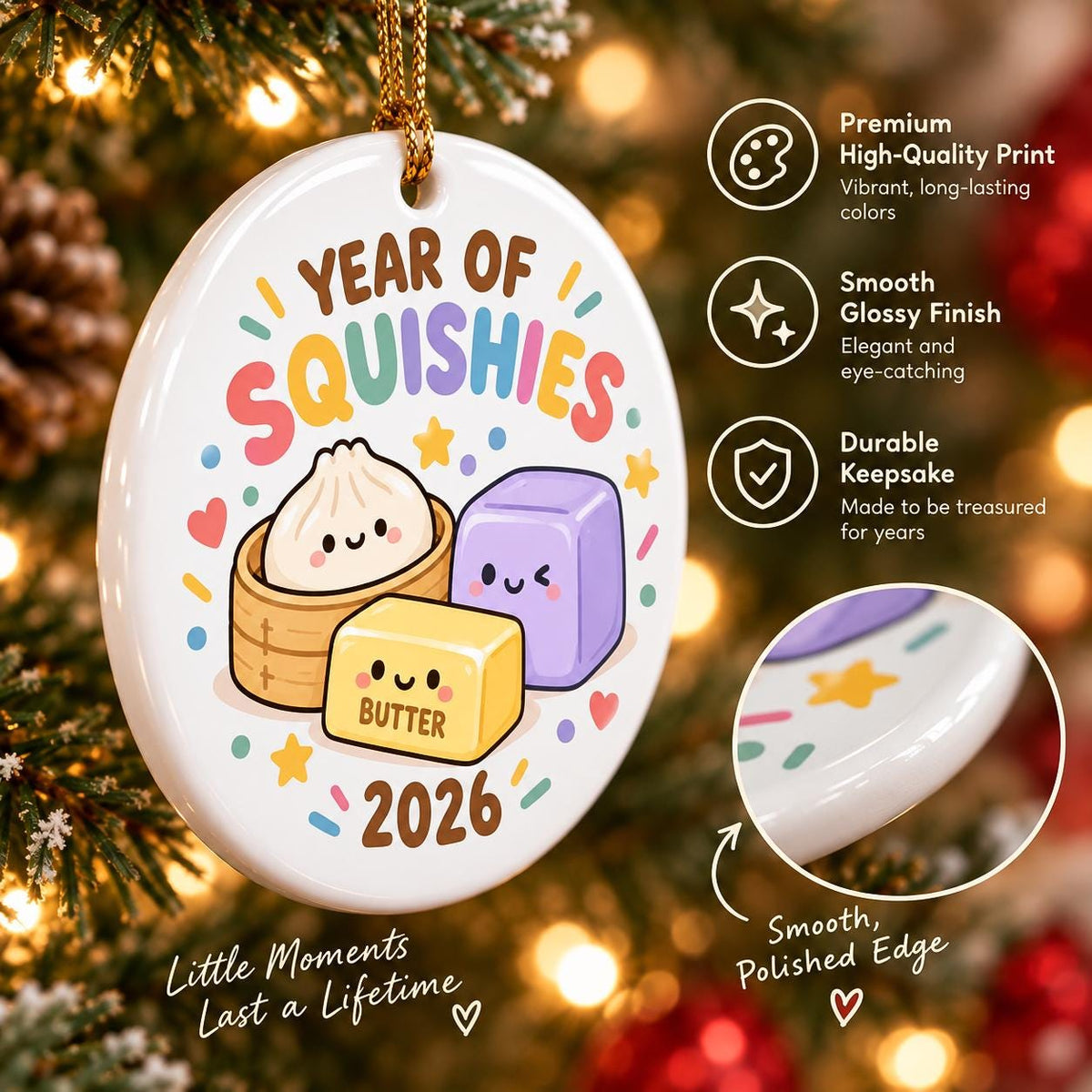 May include: A white oval ceramic ornament featuring the text Year of Squishies and 2026. The graphic displays a cartoon dumpling in a bamboo steamer, a yellow butter block, and a purple cube with faces. It includes a gold hanging string.