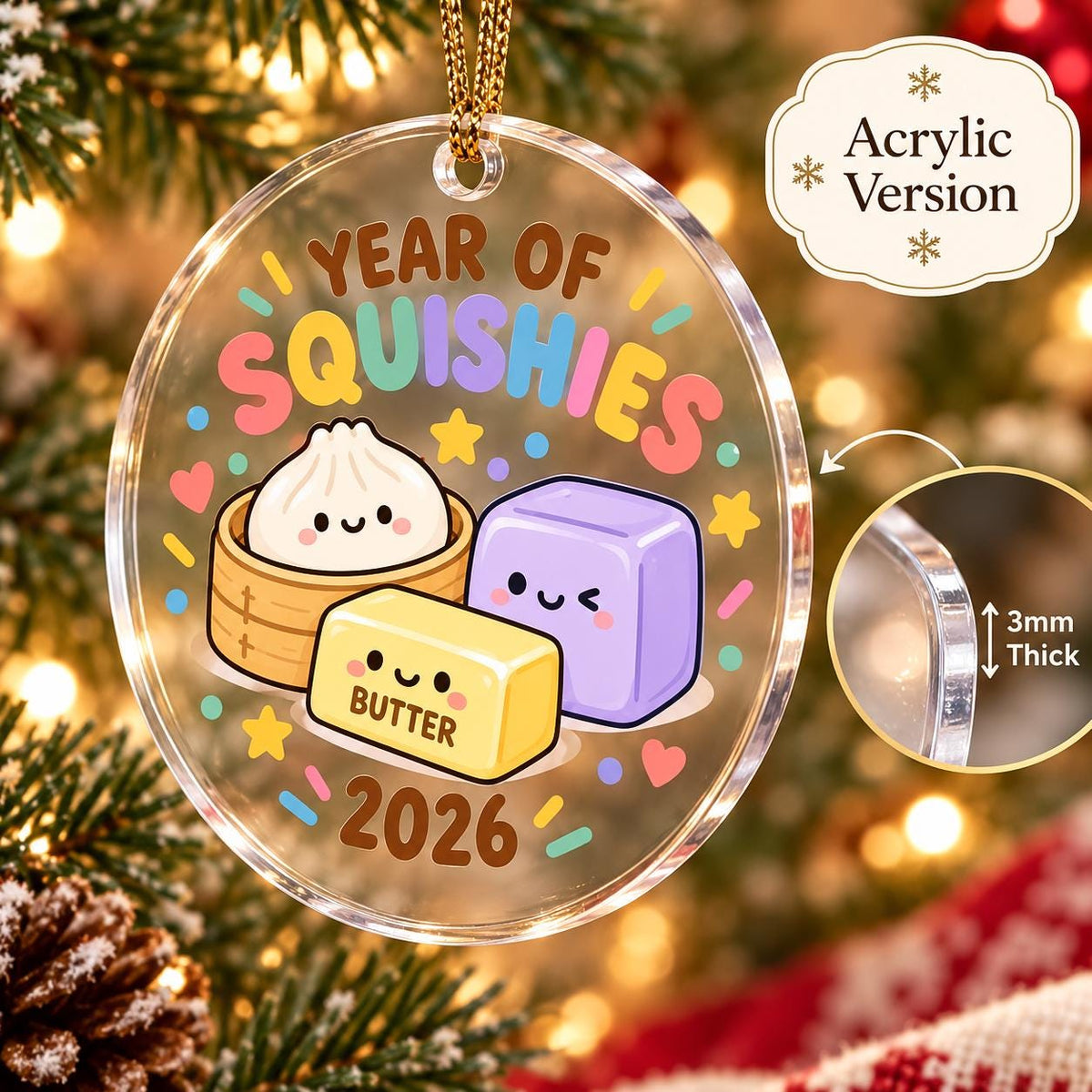 May include: A round clear acrylic ornament featuring the text Year of Squishies and 2026. The design includes a cartoon dumpling in a steamer, a yellow butter block labeled Butter, and a purple cube. A circular inset shows the material is 3mm thick.
